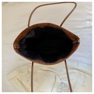 Top view of spacious leopard print tote interior with brown zipper and black lining