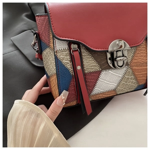 Detail of vintage patchwork crossbody bag with textured leather and silver clasp