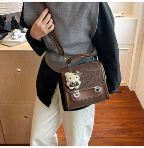 Détail du sac vintage marron avec rabat à imprimé léopard et boucles en métal argenté
