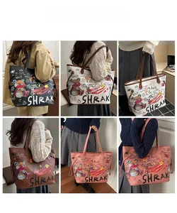 Detail view of large tote bags in black, white, brown and pink with cute cartoon graffiti