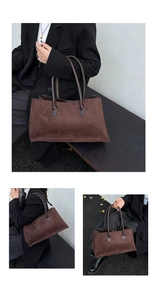 Detail view of the vintage brown faux suede tote bag featuring sleek cylindrical handles
