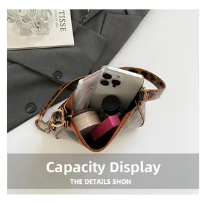Internal view of the leopard print shoulder bag showing phone and cosmetic storage