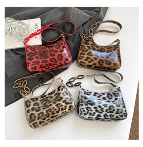 Flat lay of four leopard print glossy underarm bags in red, brown, cream, and grey with chains
