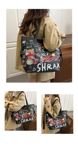 Detail of black tote bag featuring colorful cartoon bear graffiti and street art patterns