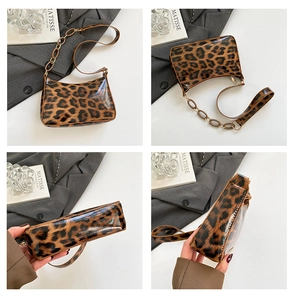 Detail view of leopard print shoulder bag with glossy patent texture and chain decoration