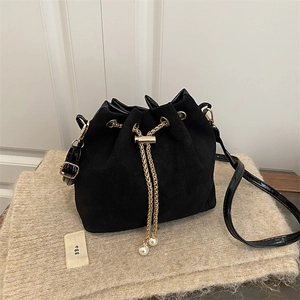 Chic black matte bucket bag with gold chain, pearl details and glossy trim accents