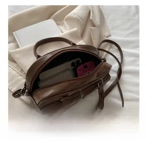 Top-view of brown vintage faux leather boston bag showing spacious interior and pockets