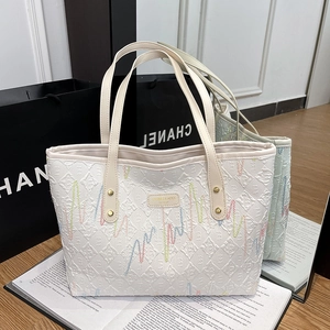Minimalist white tote bag featuring colorful wave embroidery and high-capacity design