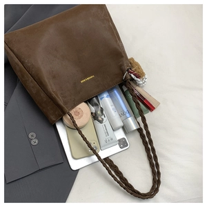 Detail view of brown vintage tote bag showing spacious interior with daily essentials
