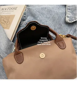 Detail of khaki nylon bag showing strong magnetic closure and premium stitching details