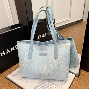 Light blue tote bag with heart wave embroidery and elegant gold metal buckles