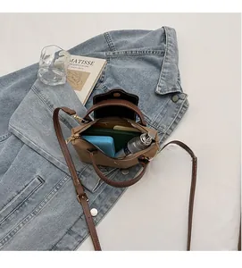 Interior view of small contrast crossbody bag showing space for phone and wallet