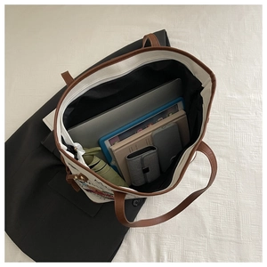 Top-down view showing spacious interior of canvas tote bag with laptop and essentials