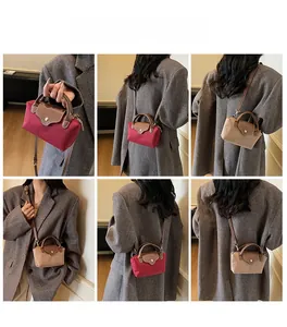 Showcase of nylon crossbody bags in red and khaki with leather flaps and handles