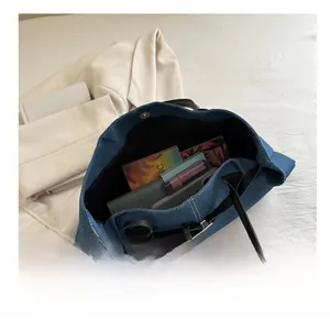 Vista dall'alto dell'interno della borsa tote in denim blu con ampio spazio interno