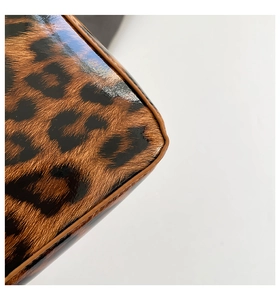 Macro shot of glossy leopard print patent leather with precise brown edge oil craftsmanship