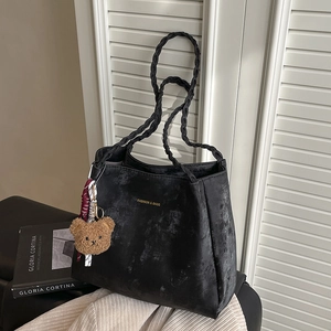 Large black vintage tote bag with woven handles and a cute brown plush bear pendant