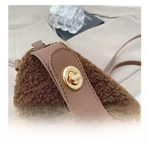 Dettaglio borsa peluche marrone caffè con chiusura a scatto in metallo dorato e pelle
