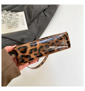 Close-up of leopard print patent leather shoulder bag showing texture and stitching details