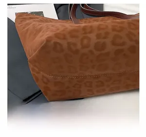 Close-up of precise stitching and matte texture on the leopard print tote bag bottom