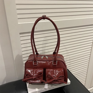 Deep red shiny faux leather shoulder bag with decorative bows and double pockets