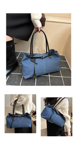 Detail view of denim tote bag showing blue fabric texture and black leather handles