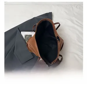 Detail view of the large capacity interior space and inner lining of the leopard tote bag