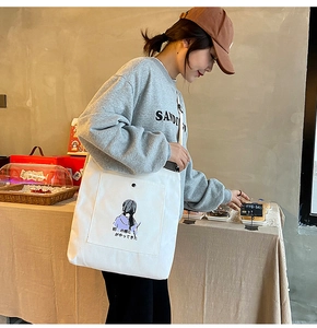Detail of white canvas tote bag with front snap pocket and Japanese illustration art