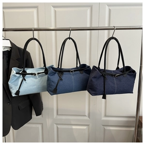 Detailed comparison of three denim tote bags in light, medium, and dark blue washes