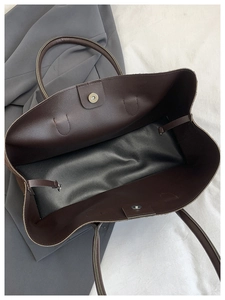 Interior detail of large vintage tote bag featuring magnetic buckle and internal hook
