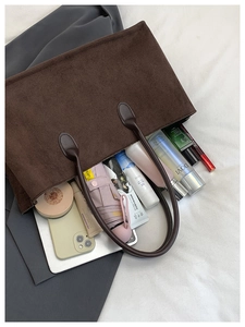 Detail of dark brown corduroy tote bag showing spacious interior with daily essentials