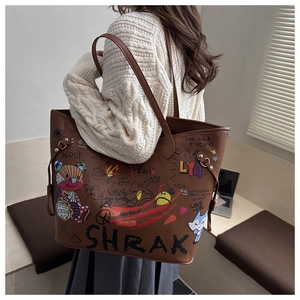 Detail showing graffiti prints and brown lychee texture on the bucket bag side