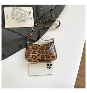 Detail of leopard print shoulder bag with chain strap and phone for size comparison