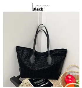 Detail of a black leopard print tote bag placed on a woven cushion in a cozy setting