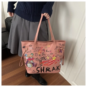 Pink graffiti bucket bag featuring street style bear graphics and durable handle detail