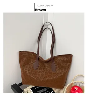 Detailed close-up of brown leopard print texture and shoulder strap on a large tote bag