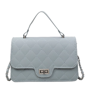 Dusty blue quilted leather crossbody bag with chain strap and gold twist lock closure
