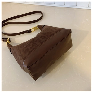 Detailed view of brown leopard pattern shoulder bag with gold metal hardware