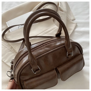Detail of dark brown faux leather Boston bag with dual pockets and adjustable strap