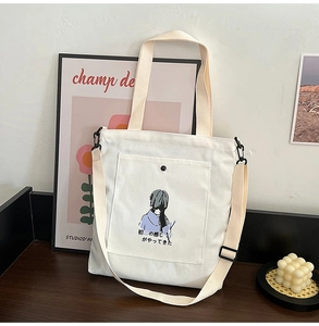 Detail of canvas tote bag with girl illustration and adjustable shoulder strap