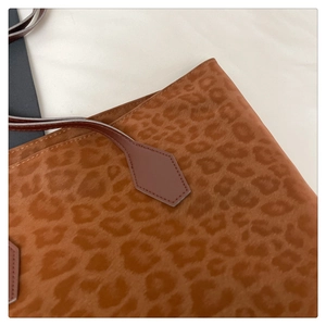 Close-up of leopard print tote bag with reinforced brown leather pentagon stitching detail