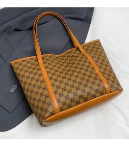 Detail of vintage geometric print tote bag with brown leather handles on a suit background