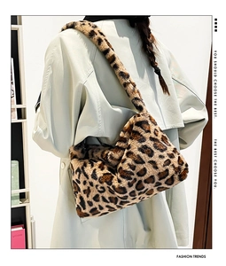 Detail of soft leopard print faux fur shoulder bag worn with a casual autumn trench coat