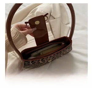 Interior view of leopard print shoulder bag showing magnetic closure and spacious compartment