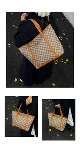 Detail of printed tote bag with orange leather trim and handles in a street setting