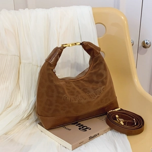 French retro leopard print half-moon shoulder bag with gold hardware and adjustable strap