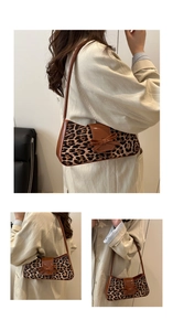 Detail of leopard print baguette bag with glossy brown leather bow and side strap