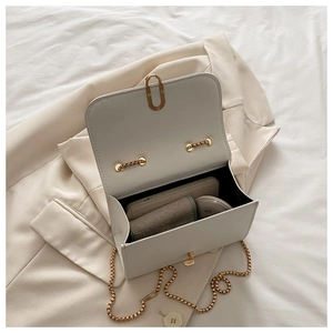 Internal view of cream small square bag showing phone and wallet storage capacity