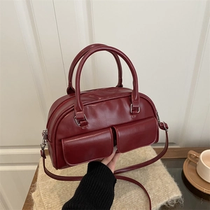 Deep red vintage Boston handbag with dual front pockets and silver hardware detailing