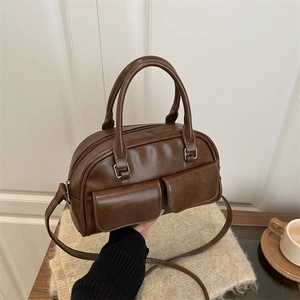 Brown retro PU leather Boston bowling bag with dual front pockets and shoulder strap
